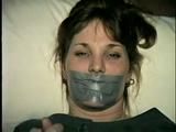 26 Yr OLD BARMAID IS BOUND, MOUTH STUFFED, HANDGAGGED & TAPE GAGGED (D27-2)