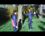 Jill and a friend of her playing with eachother in the garden while wearing shiny nylon rainwear (Video)
