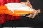 Watching Pia putting on a wonderful supersexy shiny nylon rainssuit in orange (Pics)