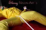 Watching sexy Pia being tied and gagged with ropes on a bed and a clothgag wearing sexy yellow shiny nylon rainwear (Pics)