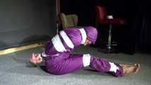 Sexy Sandra wearing a supersexy purple shiny nylon rainsuit bein tied and gagged and hooded on the floor with tape (Video)