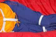 Lucy tied and gagged on a sofa wearing an orange shiny nylon rain jacket and a blue rain pants (Pics)