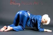 Blonde angel posing in a studio wearing sexy Blue AGU shiny nylon rainwear (Pics)