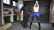 Lady M tied and spanked in shiny blue nylon shorts wearing latex Pants under the Shorts