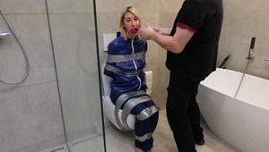 Myxxxy surprised by an Intruder in her Bathroom finally bound and gagged in Rainwear