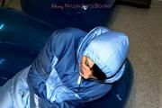 Simone tied and gagged in a shiny nylo skisuit