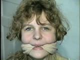 19 Yr OLD SINGLE MOM RONI IS WRAP CLEAVE GAGGED WITH AN ACE BANDAGE, HANDGAGGED, MOUTH STUFFED, BALL-GAGGED & TIED BACKWARDS TO A CHAIR (D53-9)
