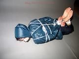 One of our archive girls tied and gagged in shiny nylon rainwear