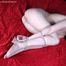 Barefoot topless Tracy in only panties, balltied with hemp rope, wiggles on the bed