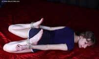 Agnes hogtied on bed