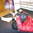 Pia tied and gagged with a bar on bed wearing a supershiny black down pants and a red down jacket (Pics)