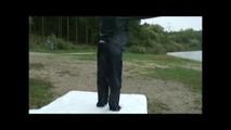 Sexy archive girl wearing shiny nylon shorts and puts on a rain pants and jacket (Video)