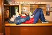 Jill posing in a bar wearing ONLY a sexy rainwear combination (Pics)