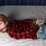 Ballgagged barefoot Carolyn, hogtied with hemp rope, wiggles on the bed