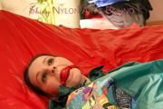 Lucy tied and gagged on bed wearing a sexy green rainwear combination (Pics)