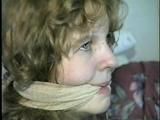 19 Yr OLD SINGLE MOM RONI IS WRAP CLEAVE GAGGED WITH AN ACE BANDAGE, HANDGAGGED, MOUTH STUFFED, BALL-GAGGED & TIED BACKWARDS TO A CHAIR (D53-9)