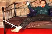 Mara tied and gagged on a princess bed in an old cellar wearing an supersexy shiny green down jacket and a rain pants (Pics)