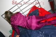 Alina preparing her bed for relaxing and lolling on the bed wearing a sexy shiny nylon rain pants and a rain jacket (Pics)
