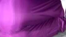 Sexy Sandra wearing a supersexy purple shiny nylon rainsuit bein tied and gagged and hooded on the floor with tape (Video)