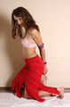 Barefoot Ekaterina in pink bra and red skirt poses for the camera with and without ropes