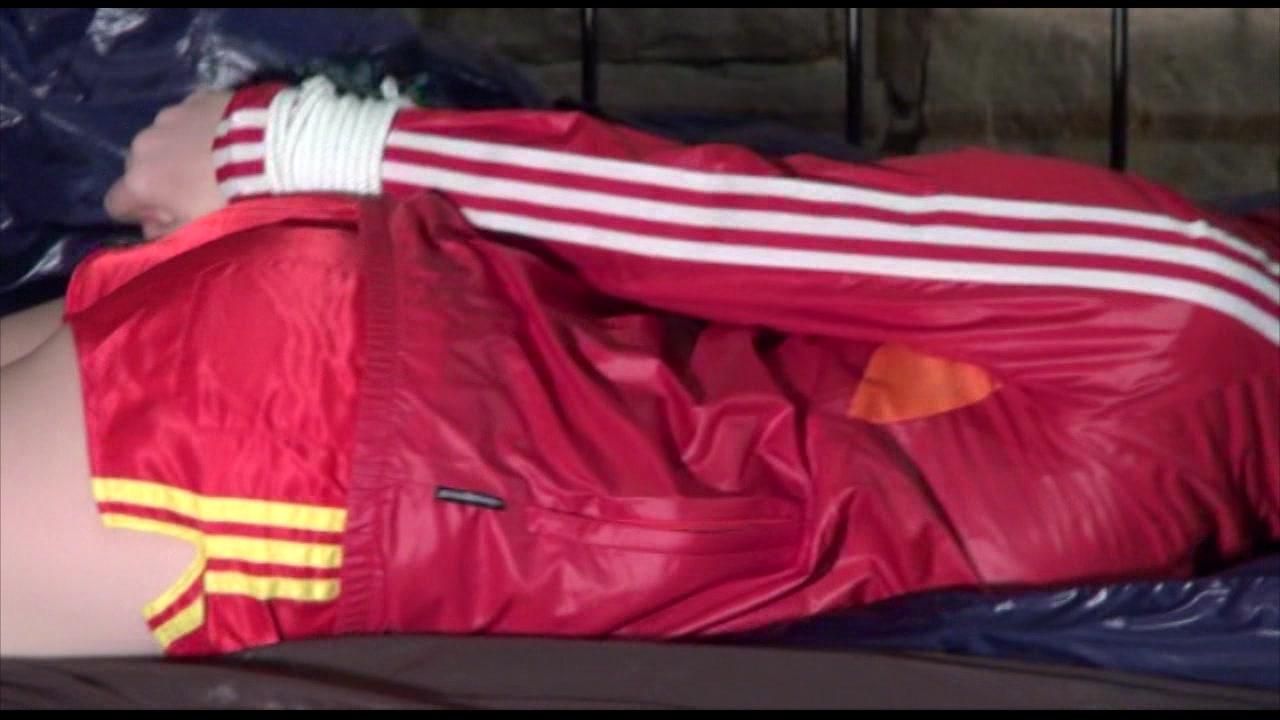 Mara Tied And Gagged On A Princess Bed In An Old Cellar Wearing A Sexy Red Shiny Nylon Shorts And A Red Rain Jacket (Video)