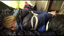 Pia tied, gagged and hooded lying on a bed with shiny nylon cloth wearing a sexy black adidas nylon pants and a blue down jacket(Video)
