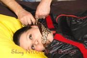 Lucy tied and gagged in a bed wearing a black shiny nylon downwear combination (Pics)