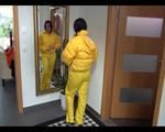 Jill wearing a yellow rain pants down jacket combination and rubber boots at home and outdoor (Video)