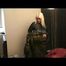 Blonde-haired archive girl going out wearing shiny nylon rainwear (Video)
