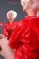 Blonde archive girl posing infront of a mirror wearing sexy red shiny nylon shorts and a red rain jacket (Pics)