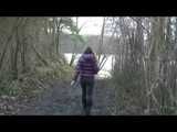 Alina wearing a jeans over a sexy shiny nylon shorts and a purple down jacket strolling on a lake (Video)