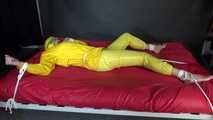 Watching sexy Pia being tied and gagged with ropes on a bed and a clothgag wearing sexy yellow shiny nylon rainwear (Video)