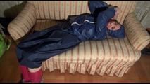 Mara tied, gagged and hooded on an old sofa wearing a cool blue rain skirt and a jacket as well as rubber boots (Video)