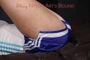 Watching sexy Pia wearing a supersexy blue shiny nylon shorts and a top being tied and gaggedoverhead with ropes and a clothgag (Pics)