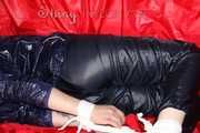 Sexy Courtney being tied and gagged with ropes and a ballgag on a bed wearing dark blue rainwear (Pics)
