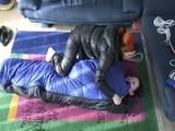 02:45 Min. video with a girl tied and gagged in a skisuit and a big shiny nylon bag to lie in from our archive