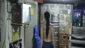 Jill in a cold room wearing shiny nylon rain pants and a down jacket (Video)