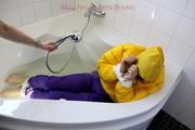 Julia tied and gagged in a ski suit in the bath tub