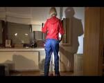 Watch Sonja to dress herself with rainwear and begin her workout on the home trainer (Video)