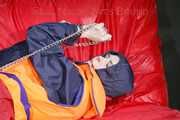 *** HOT HOT HOT*** NEW MODELL*** DESTINY wearing a sexy blue/red shiny nylon rain suit and a life jacket ties and gagges herself with cuffs on a sofa (Pics)