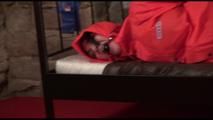 Jill tied, gagged and hooded on a princess bed wearing shiny orange rainwear (Video)