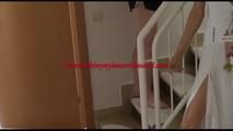 Mara tied and gagged over her head with cuffs on a stairway wearing a sexy black shiny nylon shorts and a golden rain jacket (Video)