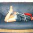 Leonie tied, gagged and hooded sitting on a sofa wearing a sexy shiny nylon shorts and a rain jacket (Pics)