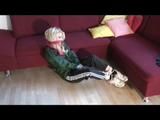 03:00 Video with Nina tied and gagged in black rainpants and a green cagoule