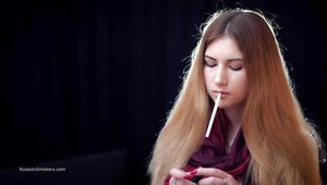 Mysterious girl Valya poses on camera with a tasty 120mm cigarette
