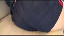 Mara tied and gagged on a white sofa wearing a blue shiny nylon shorts and a red/blue rain jacket (Video)