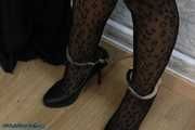 Leather lady cuffed to the heater