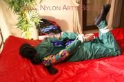Lucy tied and gagged on bed wearing a sexy green rainwear combination (Pics)