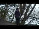 Alina wearing a jeans over a sexy shiny nylon shorts and a purple down jacket strolling on a lake (Video)