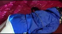 Lucy ties and gagges herself on a sofa with cuffs wearing a sexy blue shiny nylon shorts and a rain jacket (Video)
